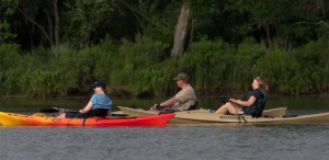 A group of local residents kayak on Galveston Bay.