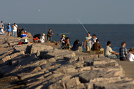 Local residents fish off the jetties in Galveston Bay.